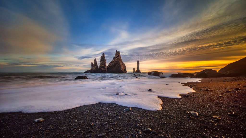 Black sea stacks of Reynisfjara at sunset near Vík, Iceland