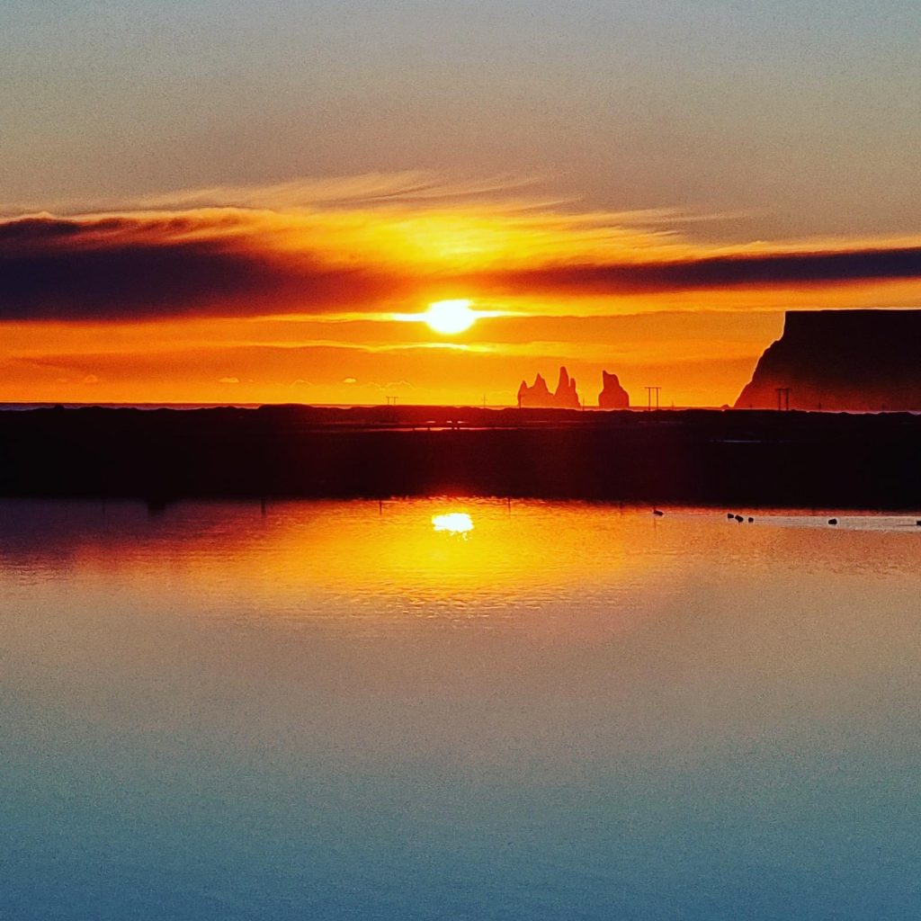 Reynisdrangar sea stacks at sunset seen from Vík, south Iceland